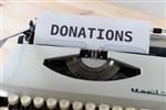 Donations typed on paper rolled into a typewriter